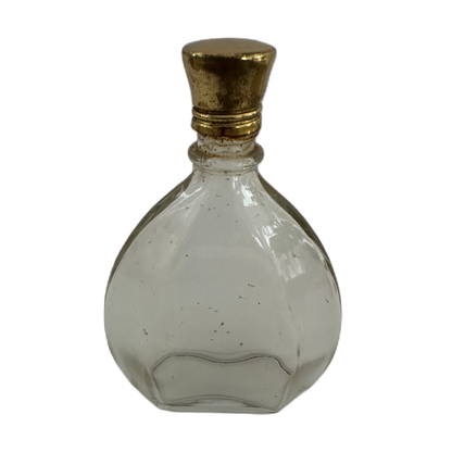 Liten parfymflaska i glas med guldfärgad metalkork.